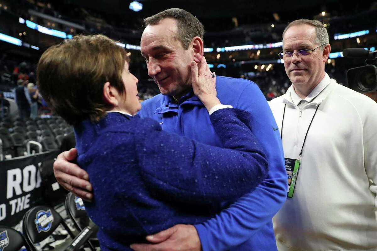 Duke head coach Mike Krzyzewski embraces his wife, Mickie, after Duke's 78-73 win over Texas Tech in NCAA Men's Basketball West Regional semifinal at Chase Center in San Francisco, Calif., on Thursday, March 24, 2022.