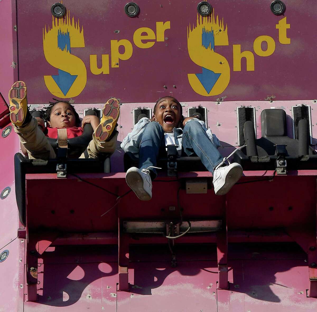 Friends Albert Moore (left) and Jamie Blanchard react as they plummet back to the ground on the Super Shot on the opening night of the YMBL South Texas State Fair Thursday. Photo made Thursday, March 24, 2022 Kim Brent/The Enterprise