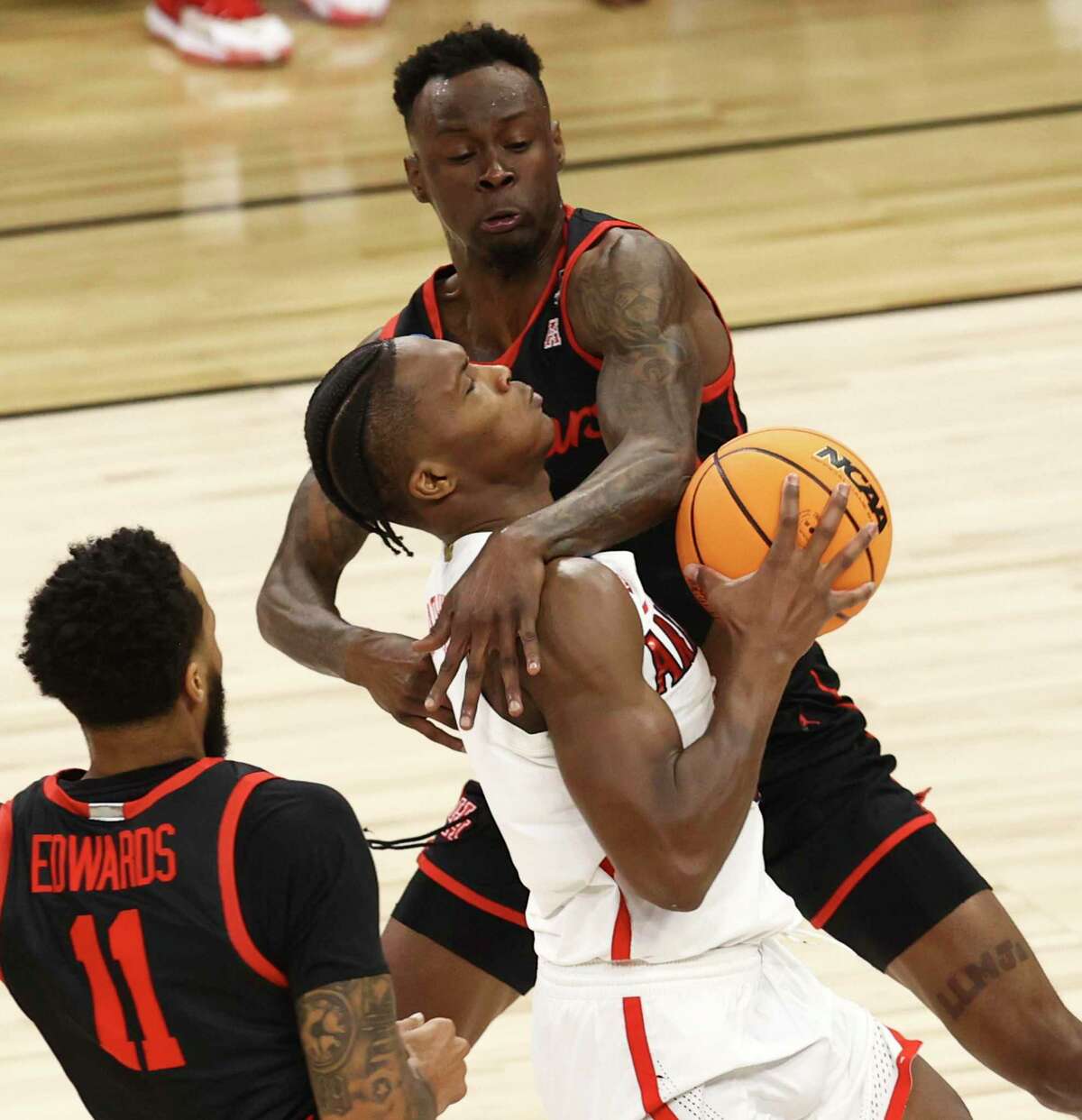 Houston Cougars guard Taze Moore (4) fouls Arizona Wildcats guard Bennedict Mathurin (0) during their game in the South Regional semifinal round of the NCAA Men's Basketball tournament at the AT&T Center on Thursday, Mar. 24, 2022.