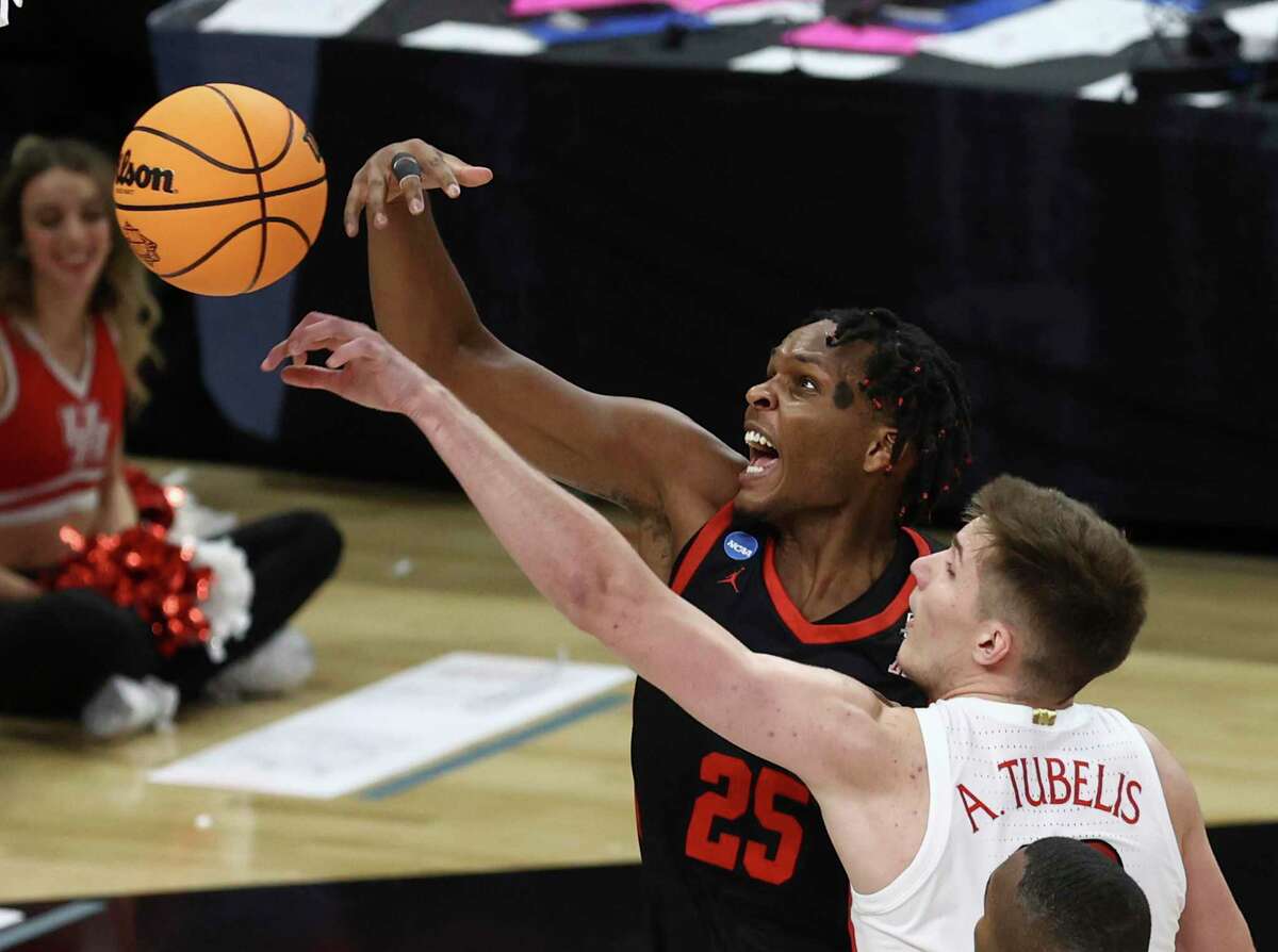 Houston Cougars center Josh Carlton (25) swats the ball from Arizona Wildcats forward Azuolas Tubelis (10) during their game in the South Regional semifinal round of the NCAA Men's Basketball tournament at the AT&T Center on Thursday, Mar. 24, 2022.