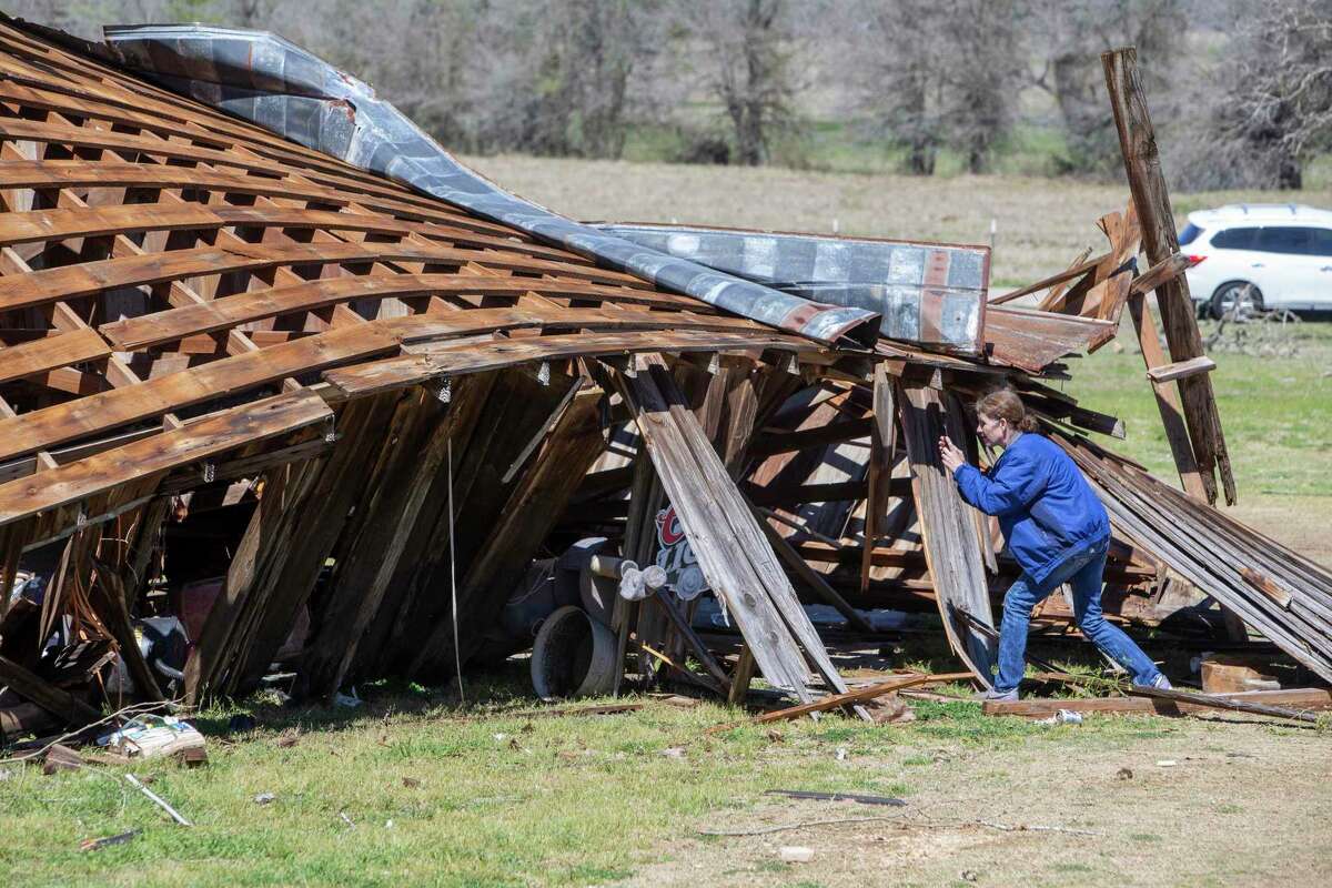 A homeowner photographs a tornado-damaged barn Tuesday, March 22, 2022, in the Kingsbury area in Guadalupe County east of Seguin. Kingsbury was under a tornado warning between 5:45 and 6:15 p.m Monday.