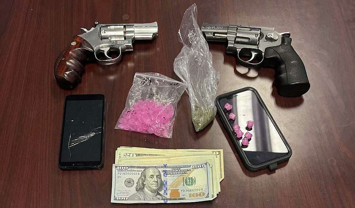 Two area men were taken into custody and charged on Wednesday, March 23, 2022, after they were allegedly found with a firearm, a BB/airsoft gun and crack cocaine capsules during a motor vehicle stop in Bridgeport, Conn., police said.