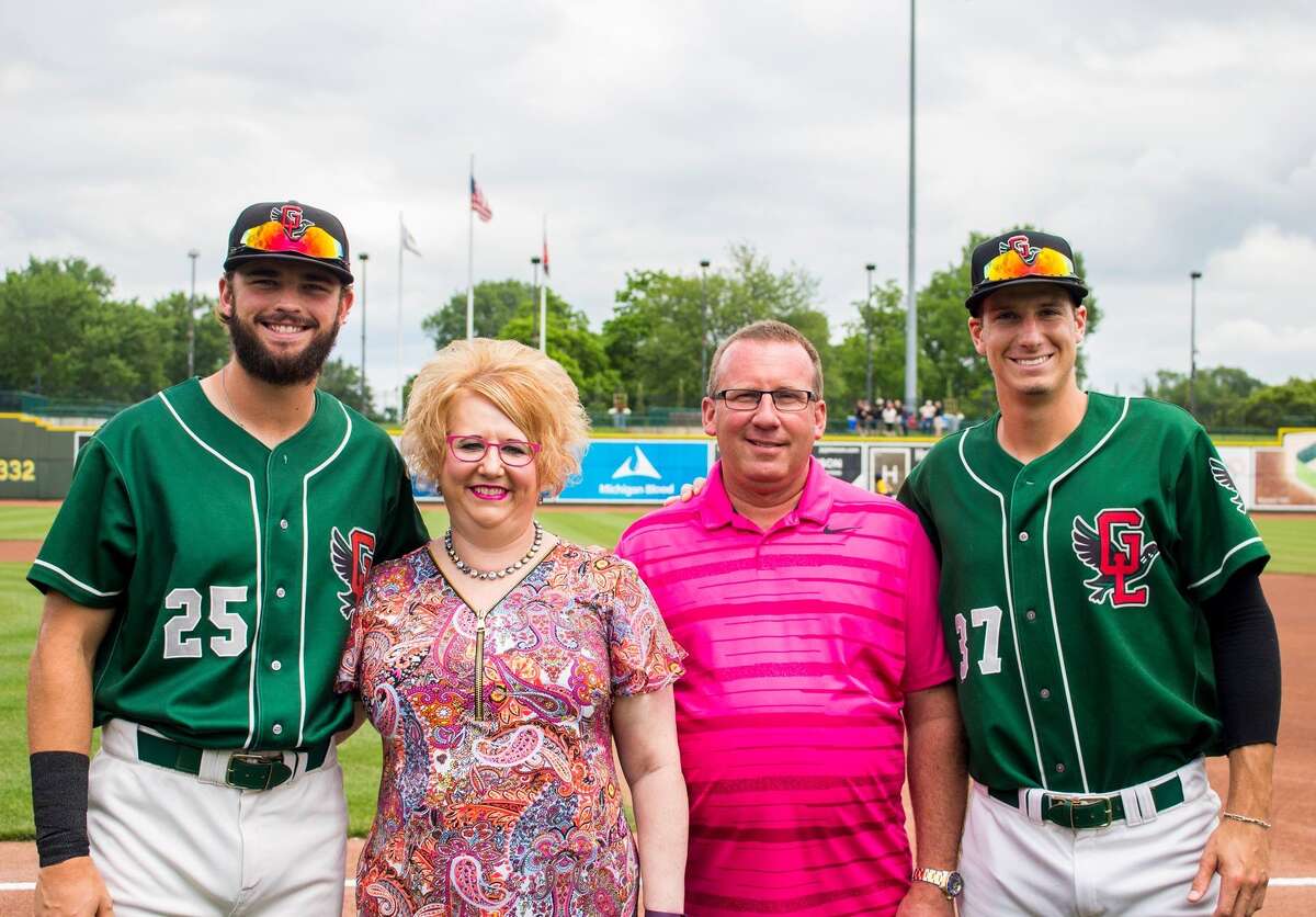 Longtime host family Michelle and Chuck Servinski, center, are pictured with Great Lakes Loons players Cody Thomas, far left, and Mitchell Hanson, far right.