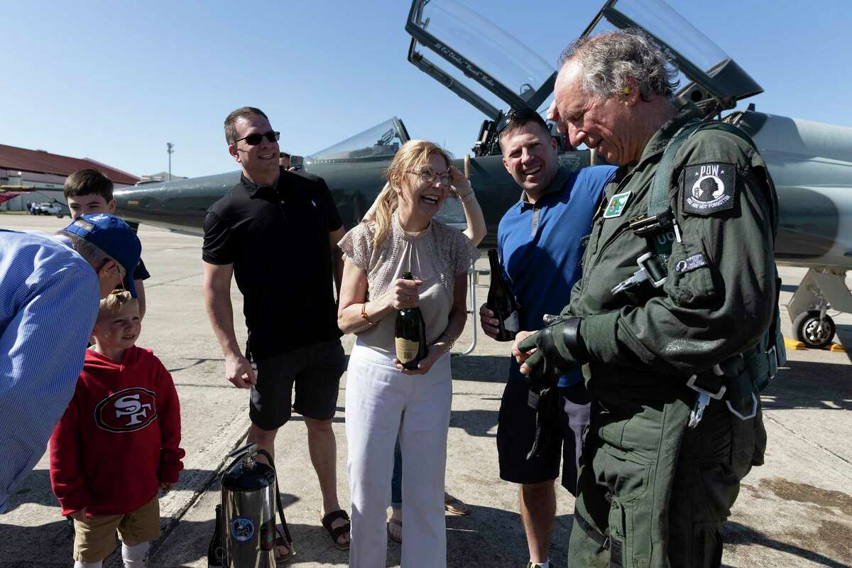 Retired Maj. Theodore “Ted” Sienicki, who was a prisoner of war in Vietnam, is greeted by his wife, Fifi, and his sons after completing his “fini” flight at Joint Base San Antonio-Randolph on Thursday.