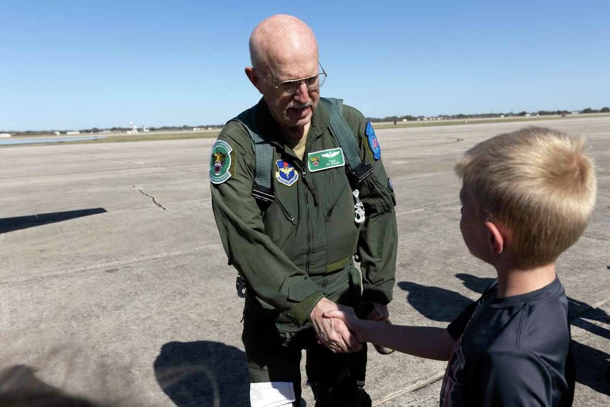 Retired Lt. Col. Frederick McMurray shakes the hand of Gavin Caywood after completing his “fini” flight at Joint Base San Antonio-Randolph. Caywood’s father is an Air Force pilot at the base.