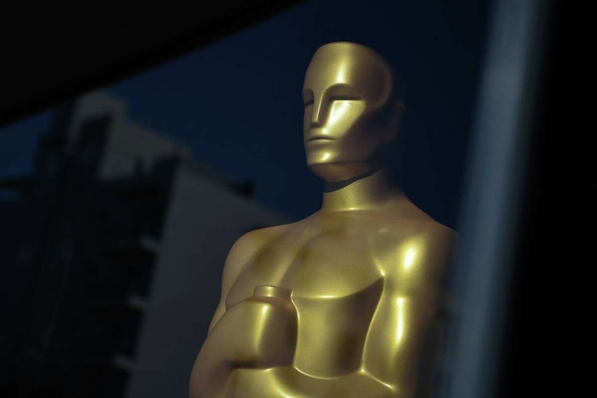 An Oscar statue is seen in the window of The Academy Museum of Motion Pictures on March 18, 2022 in Los Angeles, California. - The 94th Academy Awards will take place on March 27, 2022 at the Dolby Theatre. (Photo by Robyn Beck / AFP) (Photo by ROBYN BECK/AFP via Getty Images)