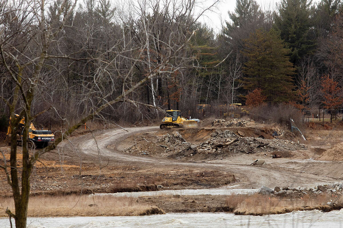 Equipment is parked on a road leading to the work site near Sanford Dam Friday, March 25, 2022 in Sanford.