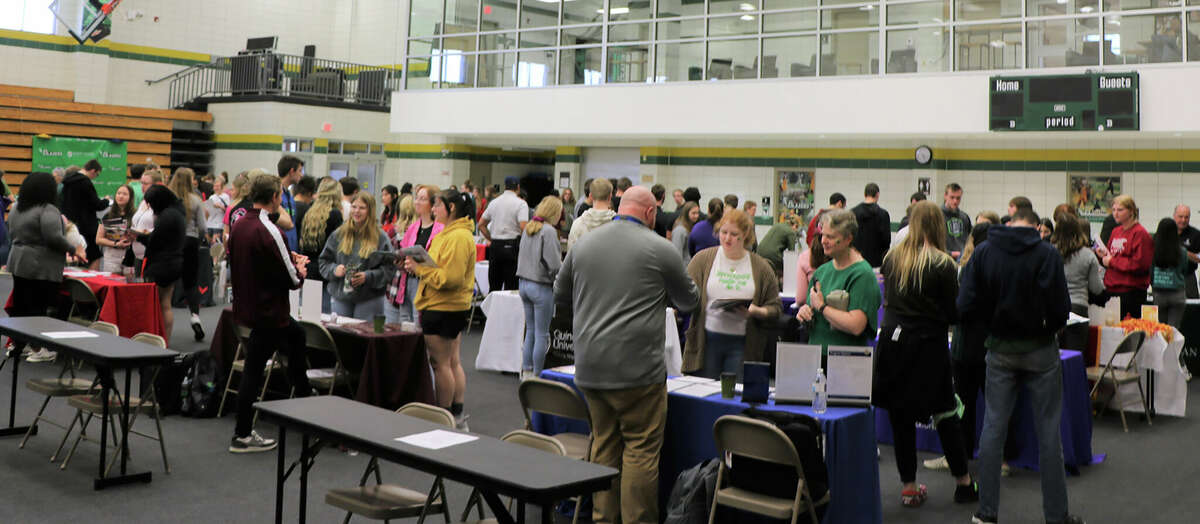 High school students talk with college admissions representatives during John Wood Community College's annual college fair. 