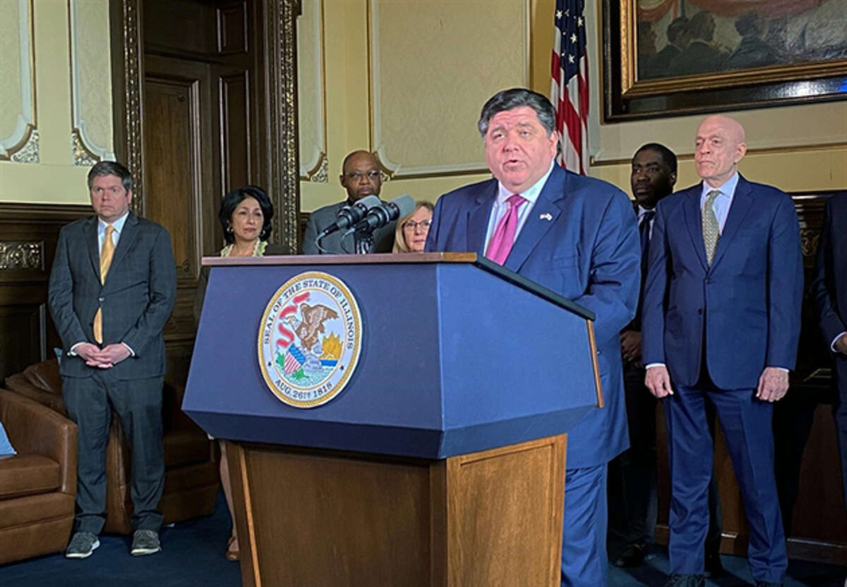 Gov. J.B. Pritzker is pictured in his office with legislative Democrats for a news conference Thursday to laud the passage of a bill directing $2.7 billion to the state's Unemployment Insurance Trust Fund and $1.4 billion to pay down other state debts. 