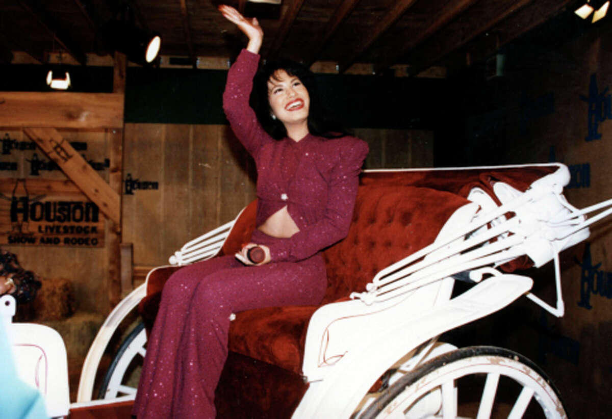 Selena rides in a carriage during a performance at the Houston Livestock Show & Rodeo at the Houston Astrodome in 1995.