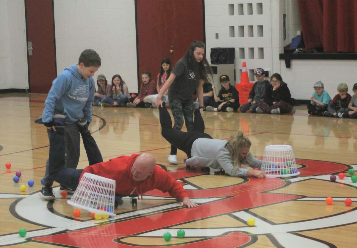 Bear Lake Schools superintendent Jakob Veith and principal Sarah Harless battle it out in a game of Hungry Human Hippos on Friday at the school to reward students for meeting their reading goal.