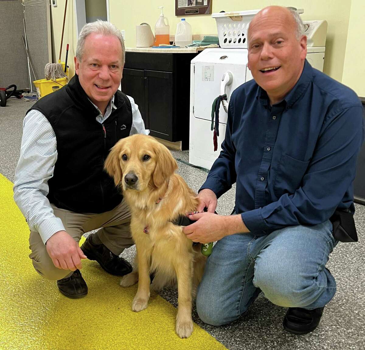 Chris Barrett and Glenn Johnson from the Christian Counseling Center of Greater Danbury with the center’s new facility dog, Apricot.