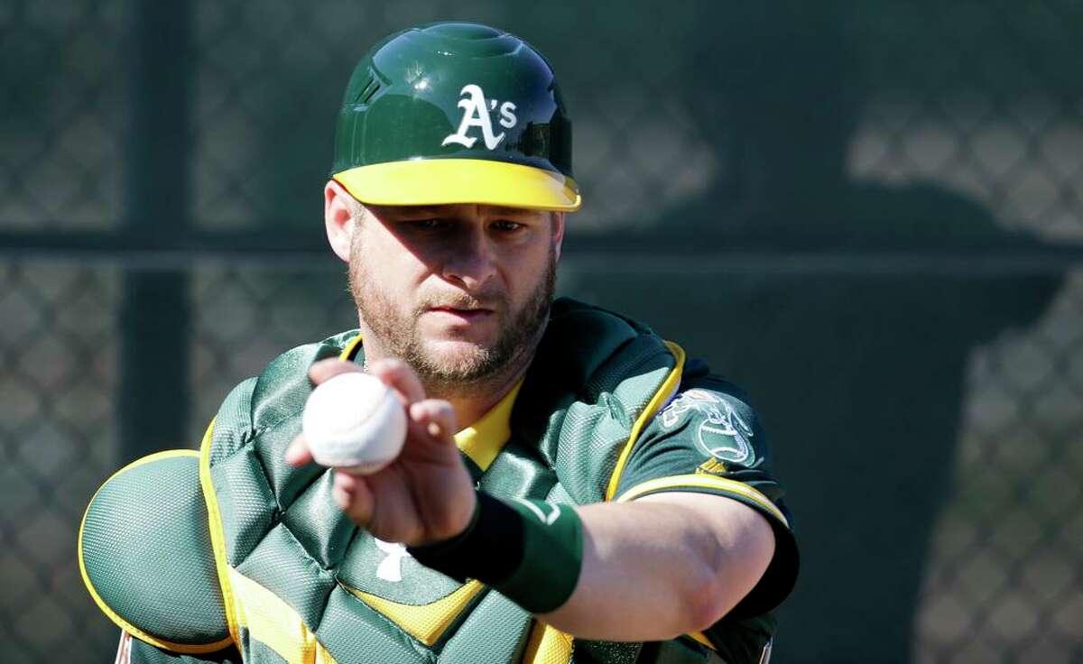 Oakland Athletics catcher Stephen Vogt works on a drill during a spring baseball practice in Mesa, Ariz., Sunday, Feb. 21, 2016. (AP Photo/Chris Carlson)