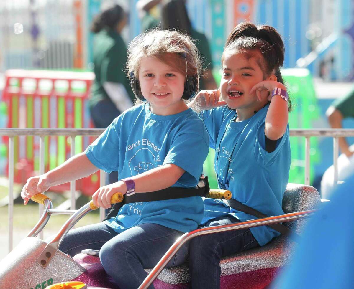 Vivian Person and Andrea Monsivais enjoys a ride during Sunshine Day at the Montgomery County Fair and Rodeo, Friday, March 25, 2022, in Conroe. Students and adults with special needs were able to enjoy the annual fair and have lunch.