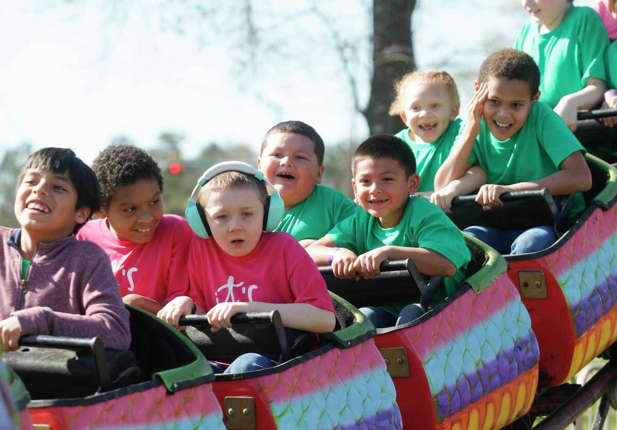 Kids enjoy a rollercoaster during Sunshine Day at the Montgomery County Fair and Rodeo, Friday, March 25, 2022, in Conroe. Students and adults with special needs were able to enjoy the annual fair and have lunch.