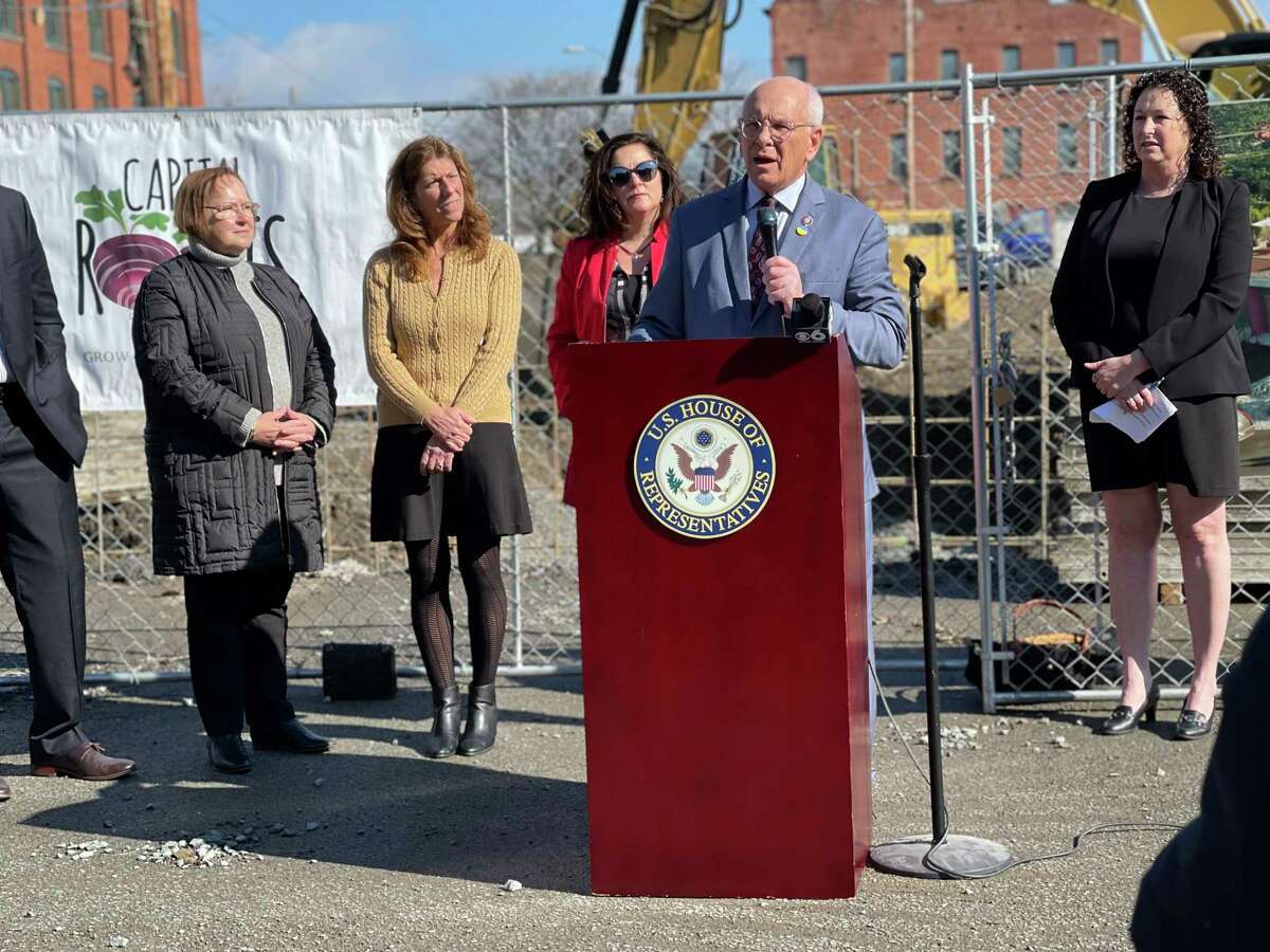 Capital Roots was awarded at $750,000 grant for its urban grow center project. Capital Roots CEO Amy Klein and Congressman Paul Tonko stand in front of the River Street site discussing its status.