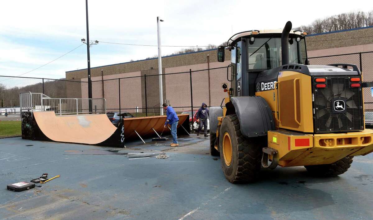 East Haven town employees dismantle the skate park at Joseph Melillo Middle School in East Haven Friday.