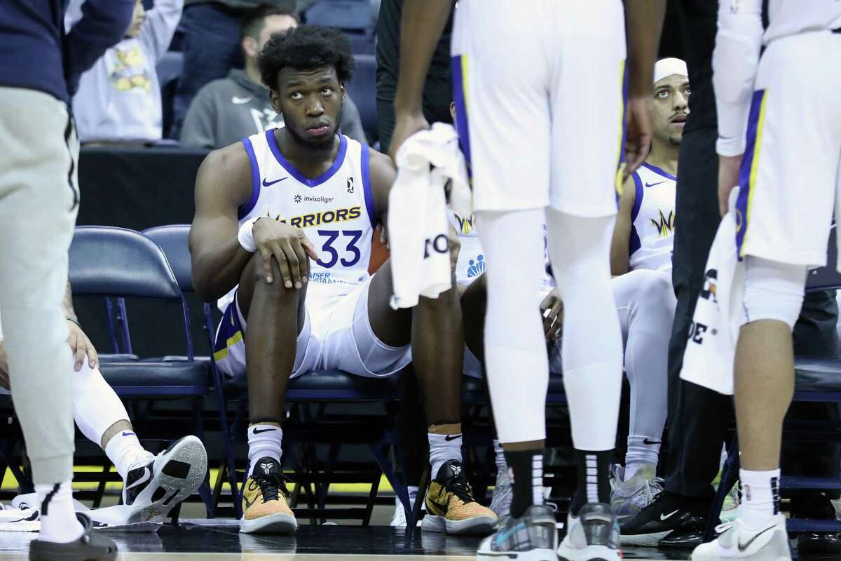 Santa Cruz Warriors' James Wiseman sits on bench before start of 4th quarter against Stockton Kings in NBA G League game at Stockton Arena in Stockton, Calif., on Thursday, March 10, 2022.