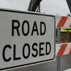 A striped road closed sign