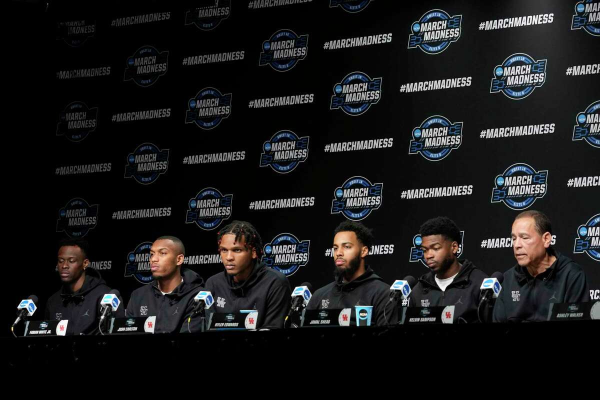Houston basketball players, from left, Taze Moore, Fabian White Jr., Josh Carlton, Kyler Edwards , Jamal Shead and head coach Kelvin Sampson sit down for a news conference leading up to the NCAA South Region men’s basketball final against Villanova Friday, March 25, 2022 in San Antonio.