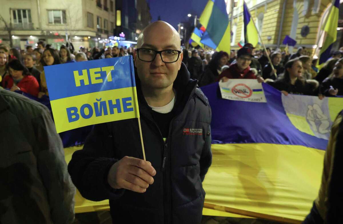A man carries Ukrainian flag with sign "No War" during mass protest against Russia's invasion of Ukraine and to show solidarity with Ukrainians in Sofia, on Thursday, March 24, 2022. The rally, organized on social networks, followed Ukrainian President Volodymyr Zelenskyy's call on people around the globe to protest the month-long war. (AP Photo/Valentina Petrova)