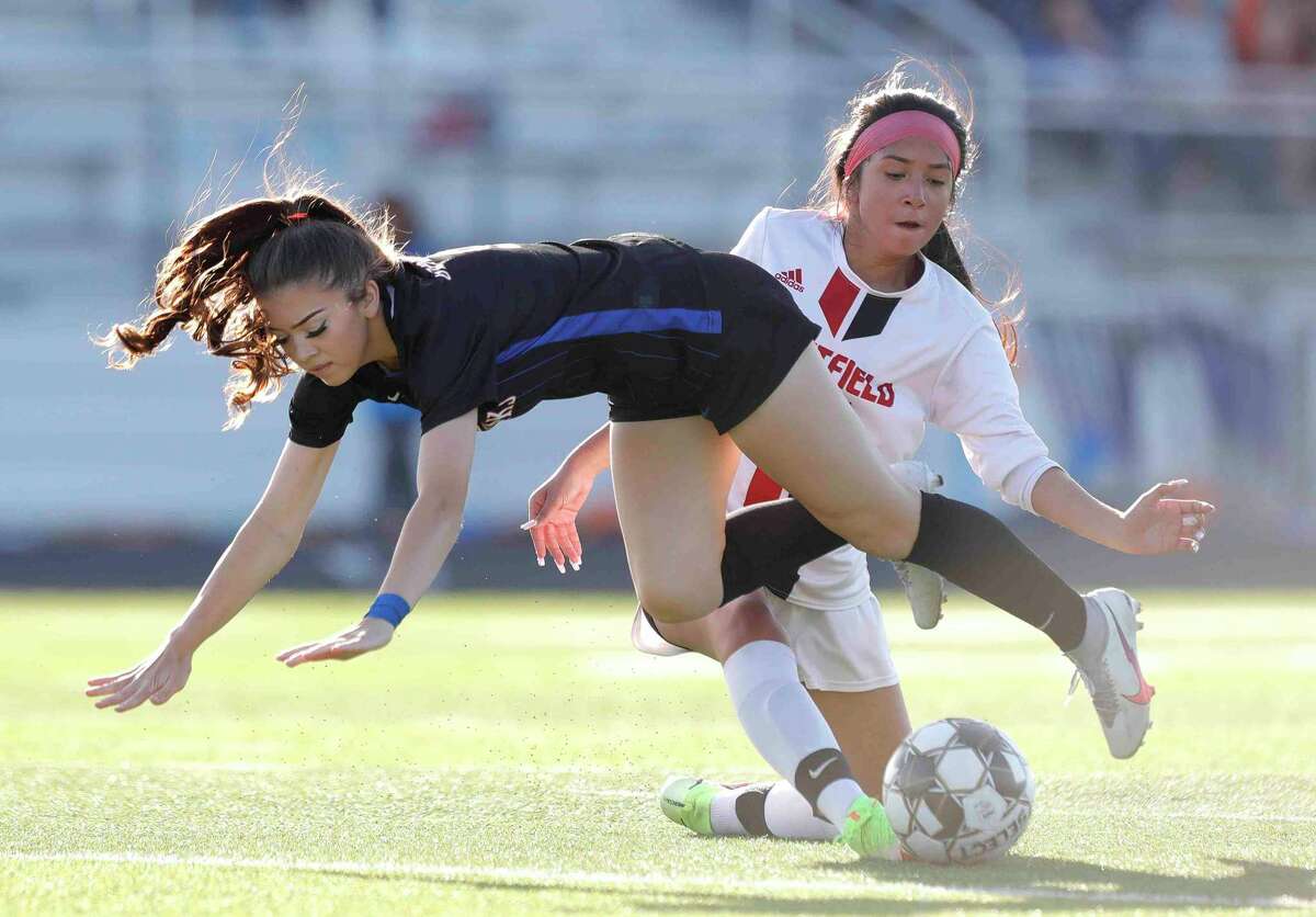 Grand Oaks' Rylee Friedrich (9) gets tripped up by Westfield's Arleen Rodriguez (23) during the first period of a Region II-6A bi-district high school soccer match at Grand Oak High School, Friday, March 25, 2022, in Spring.