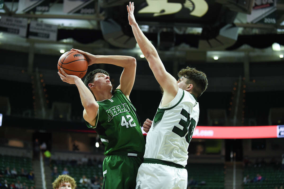 Freeland's Alex Duley shoots over a defender during the Falcons' state semifinal game against Williamston High School at Friday, March 25, 2022 Michigan State University.