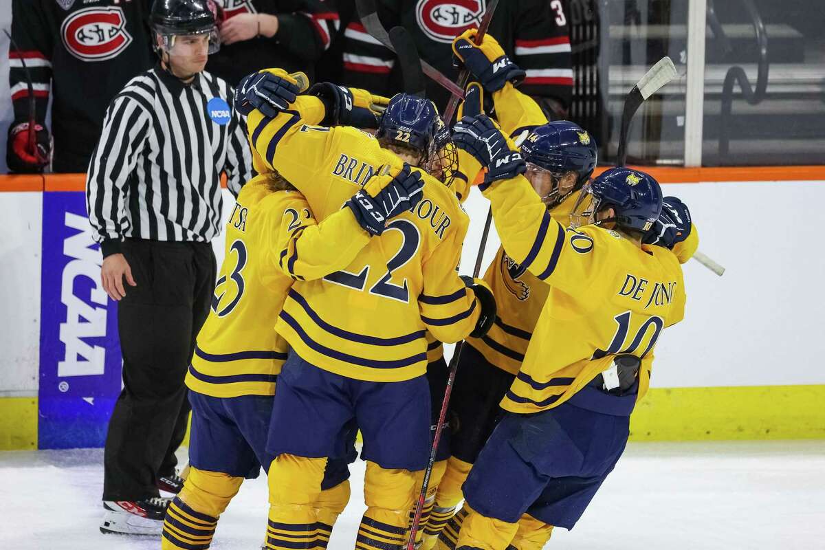 Members of the Quinnipiac men’s hockey team celebrate during their win over St. Cloud State on Friday.