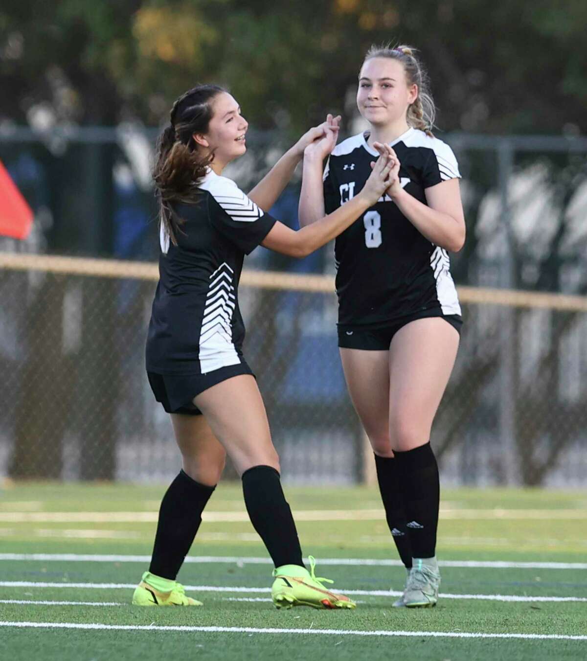 Clark's Emily Hight (08) gets congratulated by Logan Garza (06) after Hight scores one of her three goals against Clemens in girls soccer playoffs at Farris Stadium on Friday, Mar. 25, 2022. Clark defeated Clemens, 9-2, to move on in the next round of playoffs.