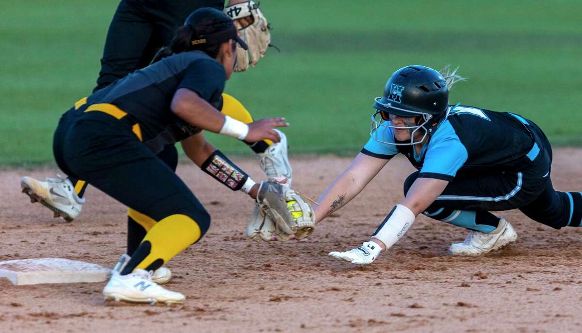 Harlan runner Harleigh Aguirre is tagged out at second base Friday night, March 25, 2022 by Brennan’s Dayanara Moreno.