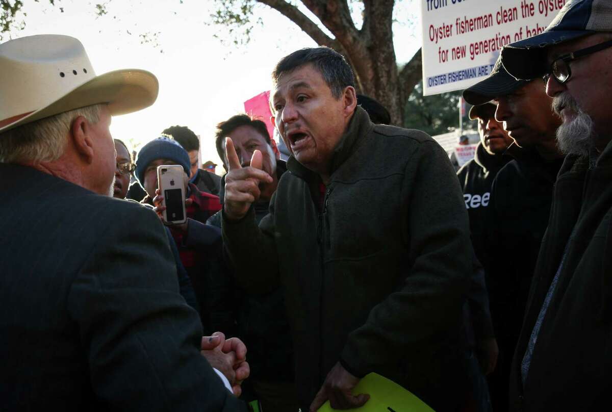Pablo Cervantes, an oyster fisherman, argues with a former game warden before a Texas Parks and Wildlife commission meeting Thursday, March 24, 2022, at the TPWD headquarters in Austin. TPWD had sought to close three public reefs to oyster harvesting because of declining oyster populations, and the fishermen protested those closures. “He don’t know what he’s talking about,” Cervantes said. The former game warden spoke in favor of the closures during the meeting.