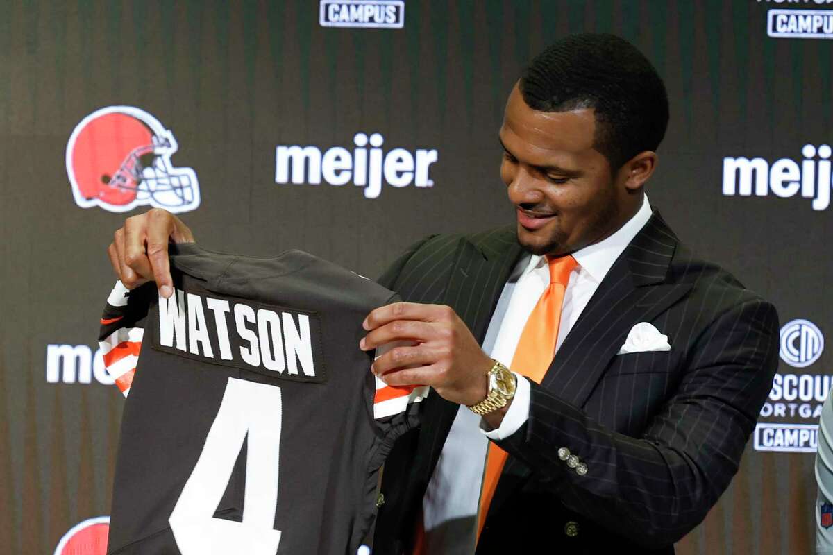 Cleveland Browns new quarterback Deshaun Watson holds his jersey during a news conference at the NFL football team's training facility, Friday, March 25, 2022, in Berea, Ohio. (AP Photo/Ron Schwane)