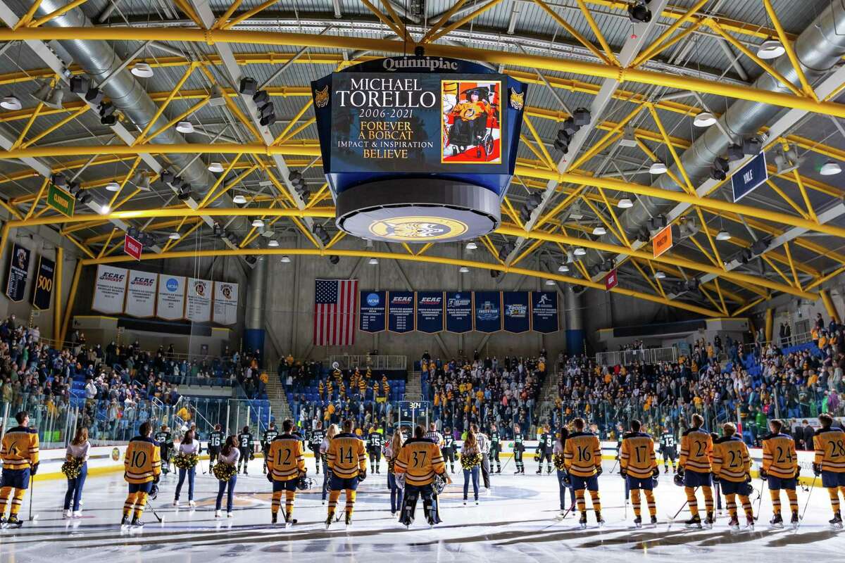 Quinnipiac's men's hockey team lines up at the blue line to honor Team IMPACT teammate Michael Torello before an Oct. 23, 2021 game against North Dakota at Perrotti Arena. Torello died July 30, 2021.