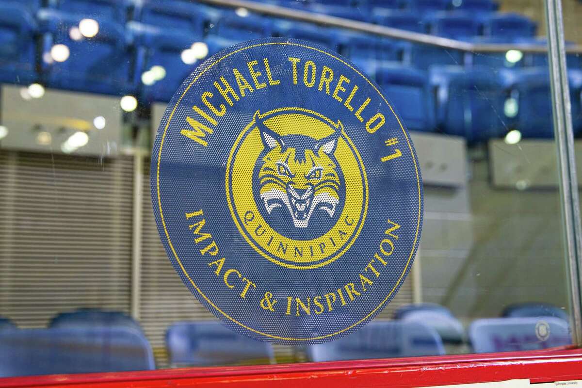 A sticker on the glass behind the home net at Perrotti Arena honors Michael Torello, who died July 30, 2021. Torello was the men's hockey team's Team IMPACT teammate.