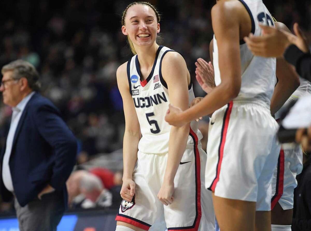UCONN's Paige Bueckers is all smiles during the final moments of her team's 75-58 defeat of Indiana in their Sweet Sixteen NCAA basketball tournament game at the Total Mortgage Arena in Bridgeport, Conn., on Saturday, March 26, 2022.