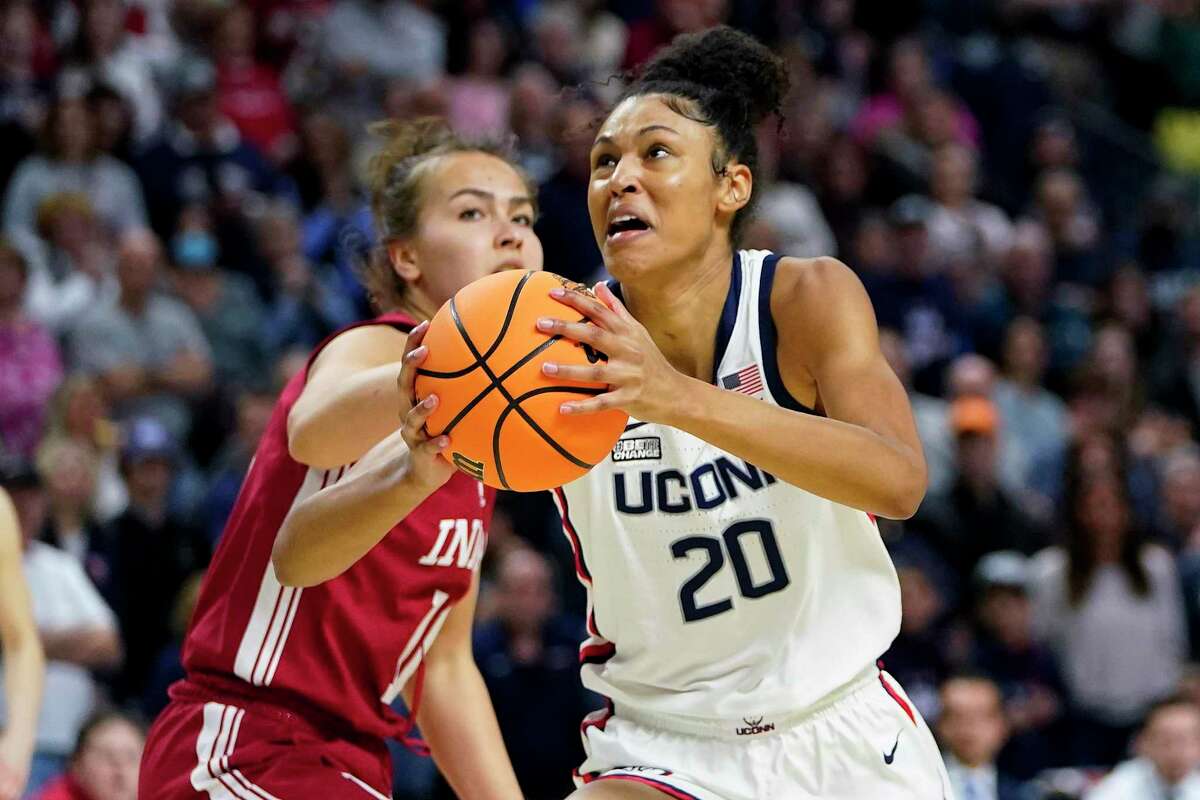 Connecticut forward Olivia Nelson-Ododa (20) drives to the basket against Indiana forward Aleksa Gulbe (10) during the first quarter of a college basketball game in the Sweet Sixteen round of the NCAA women's tournament, Saturday, March 26, 2022, in Bridgeport, Conn. (AP Photo/Frank Franklin II)