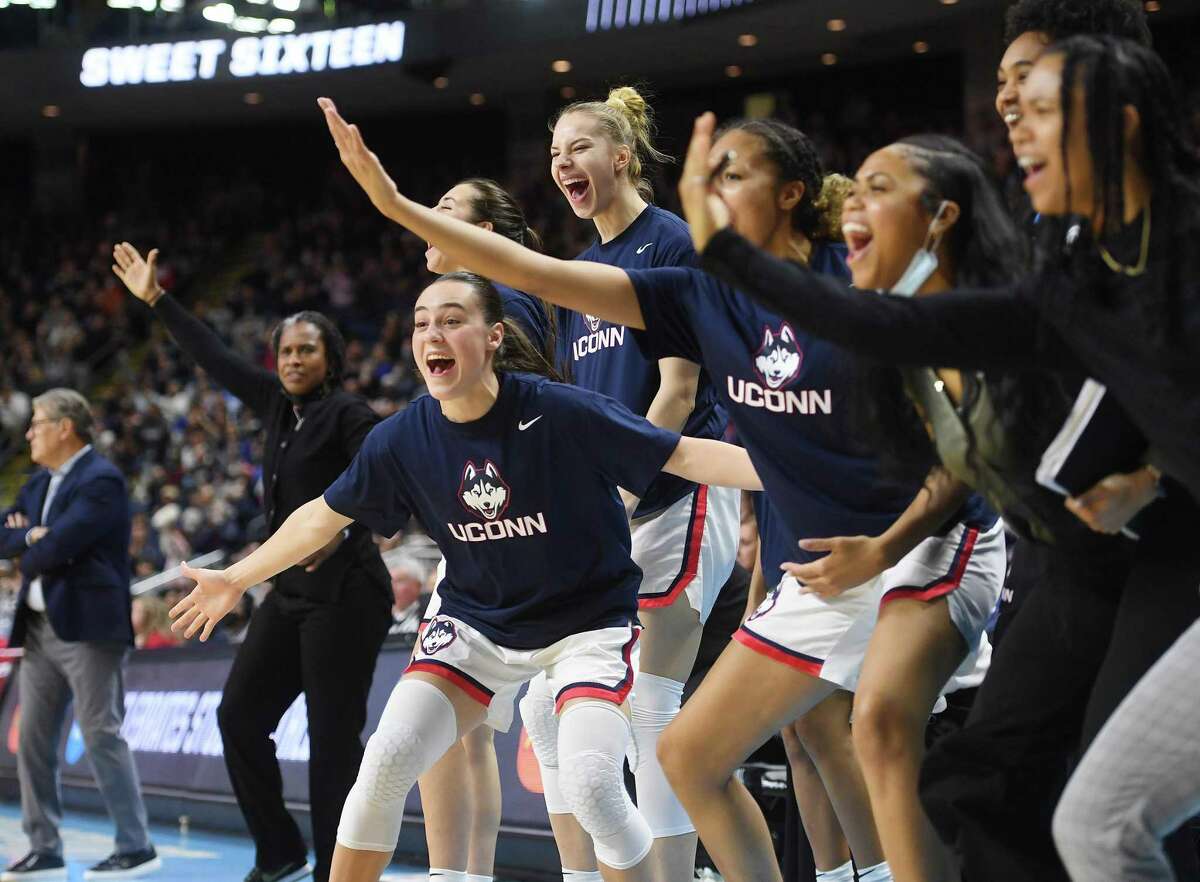 The UCONN bench celebrate a Paige Bueckers basket during a second half run in their team's 75-58 defeat of Indiana in their Sweet Sixteen NCAA basketball tournament game at the Total Mortgage Arena in Bridgeport on Saturday.