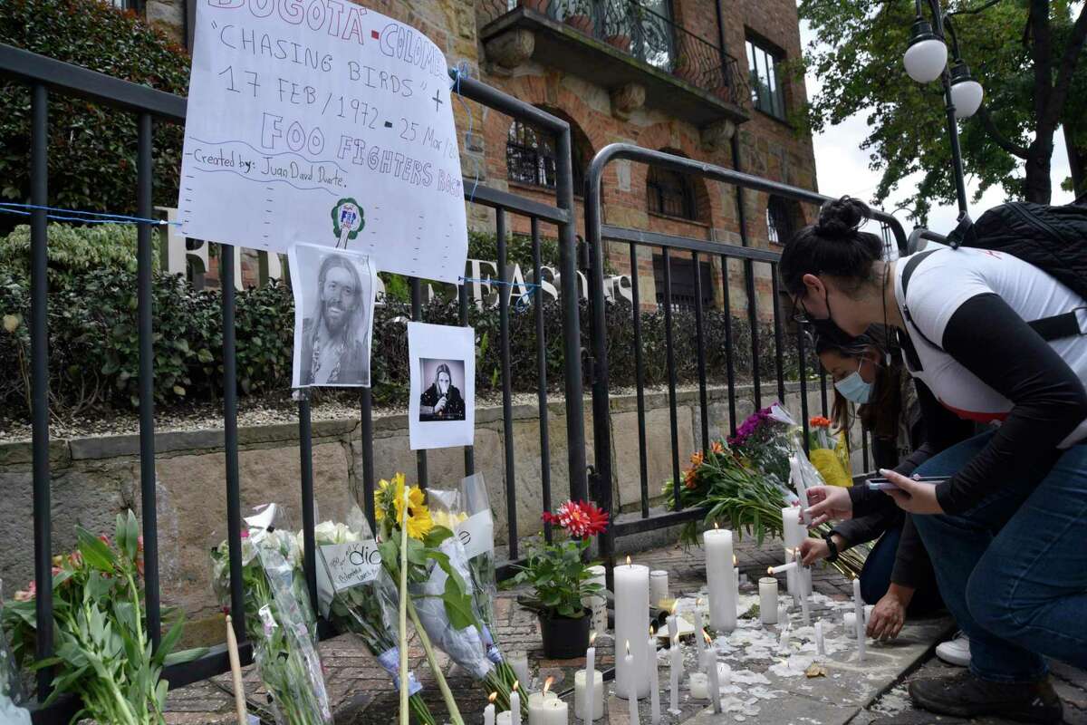 Foo Fighters fans place candles outside Casa Medina Hotel in Bogota, Colombia, where drummer Taylor Hawkins was found dead Friday.