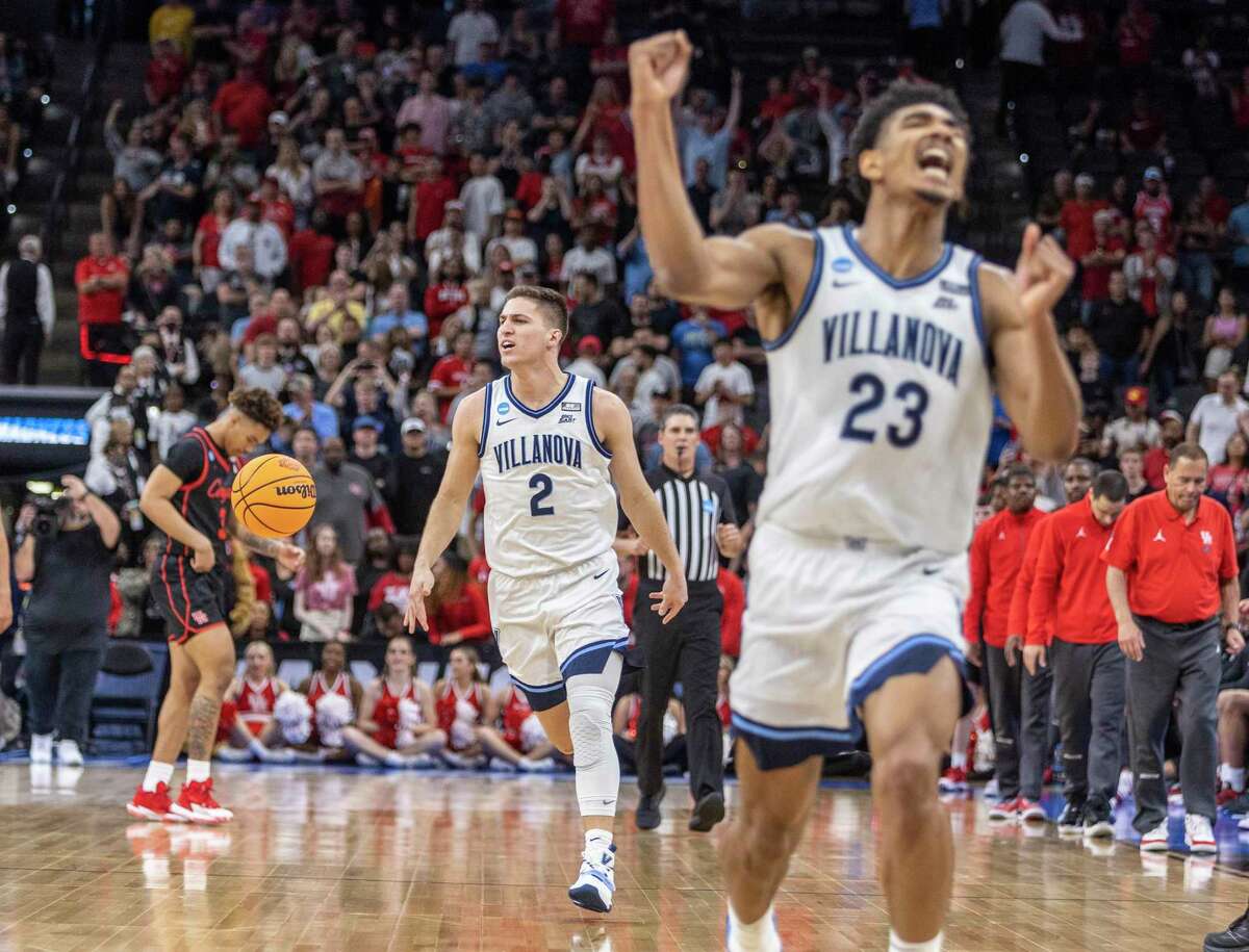 Villanova Wildcats guard Collin Gillespie (2), left, and forward Jermaine Samuels (23) celebrate at the AT&T Center, Saturday, March 26, 2022, in San Antonio, Texas after beating the Houston Cougars 50-44 in their NCAA Elite Eight matchup.