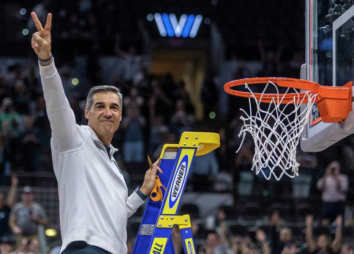 Villanova Wildcats head coach Jay Wright acknowledges the fans at the AT&T Center, Saturday, March 26, 2022, in San Antonio, Texas while cutting down the net after beating the Houston Cougars 50-44 in their NCAA Elite Eight matchup.