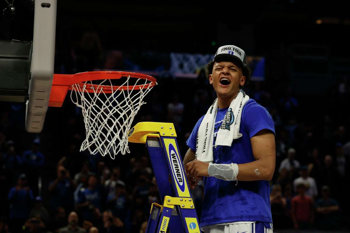 Duke forward Paolo Banchero takes his turn during a net-cutting ceremony after the Blue Devils advanced to the Final Four.