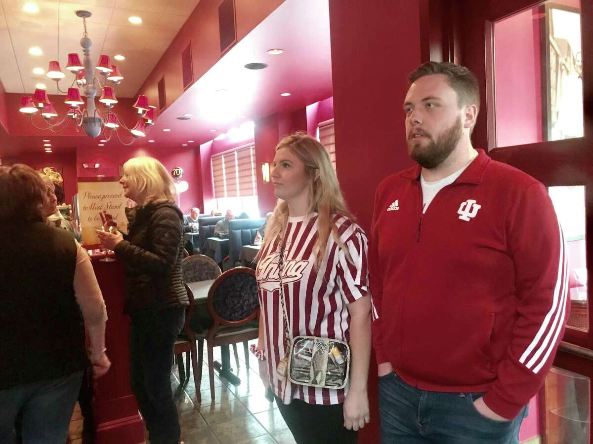 Indiana Hoosiers basketball fans enter Ralph-n-Rich’s restaurant in downtown Bridgeport after their team lost to UConn Saturday afternoon