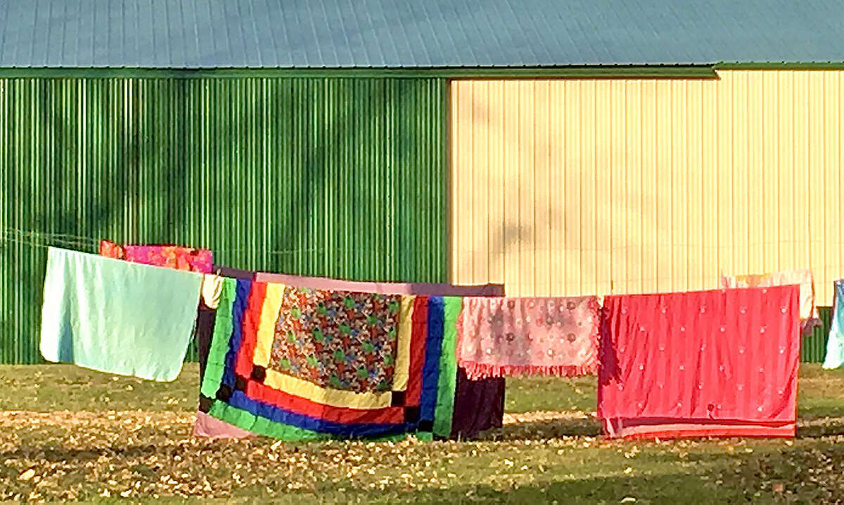 Colorful quilts dry in the spring sunshine.
