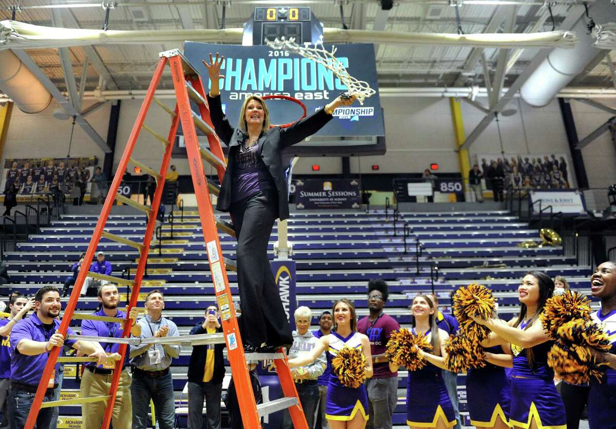 UAlbany coach Katie Abrahamson-Henderson, center, twirls the net after cutting it down as the team celebrates its 59-58 win over Maine in the America East Women's Basketball Championship game on Friday, March 11, 2016, at SEFCU Arena in Albany, N.Y. (Cindy Schultz / Times Union)