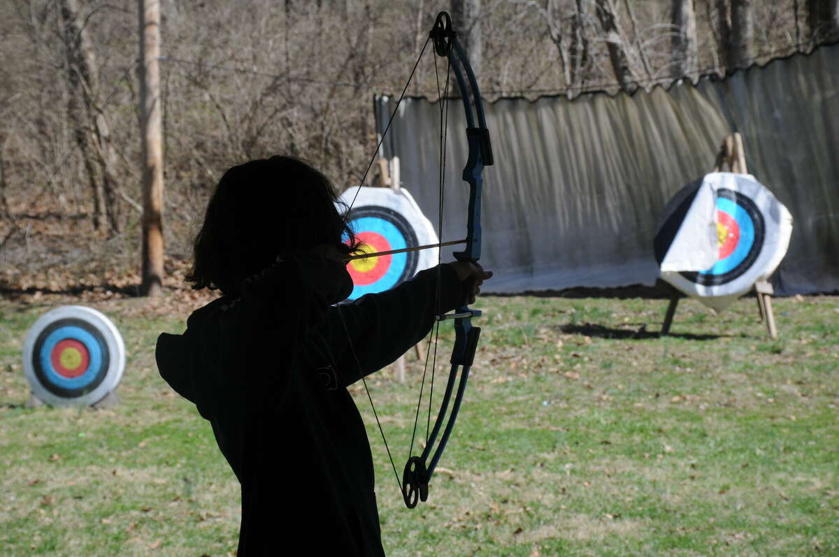 Micah Louvierre of Oakville, Missouri takes aim at the archery range during the Taste of Venturing in Godfrey this weekend.