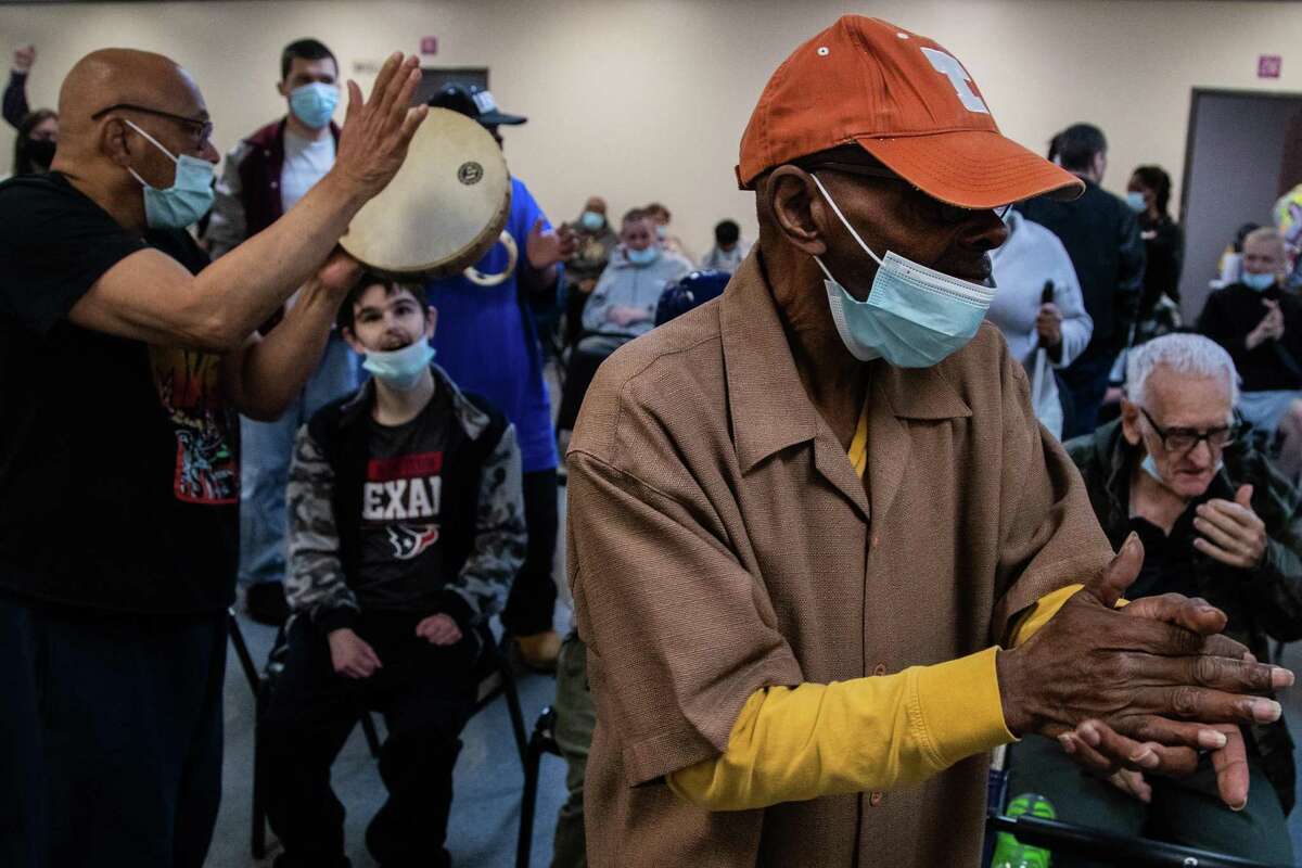 Preston Williams sings and applauds as he participates at a praise and worship service at Caregiver Inc., which provides long-term care services to individuals with disabilities, Wednesday, March 16, 2022, in Sugar Land.