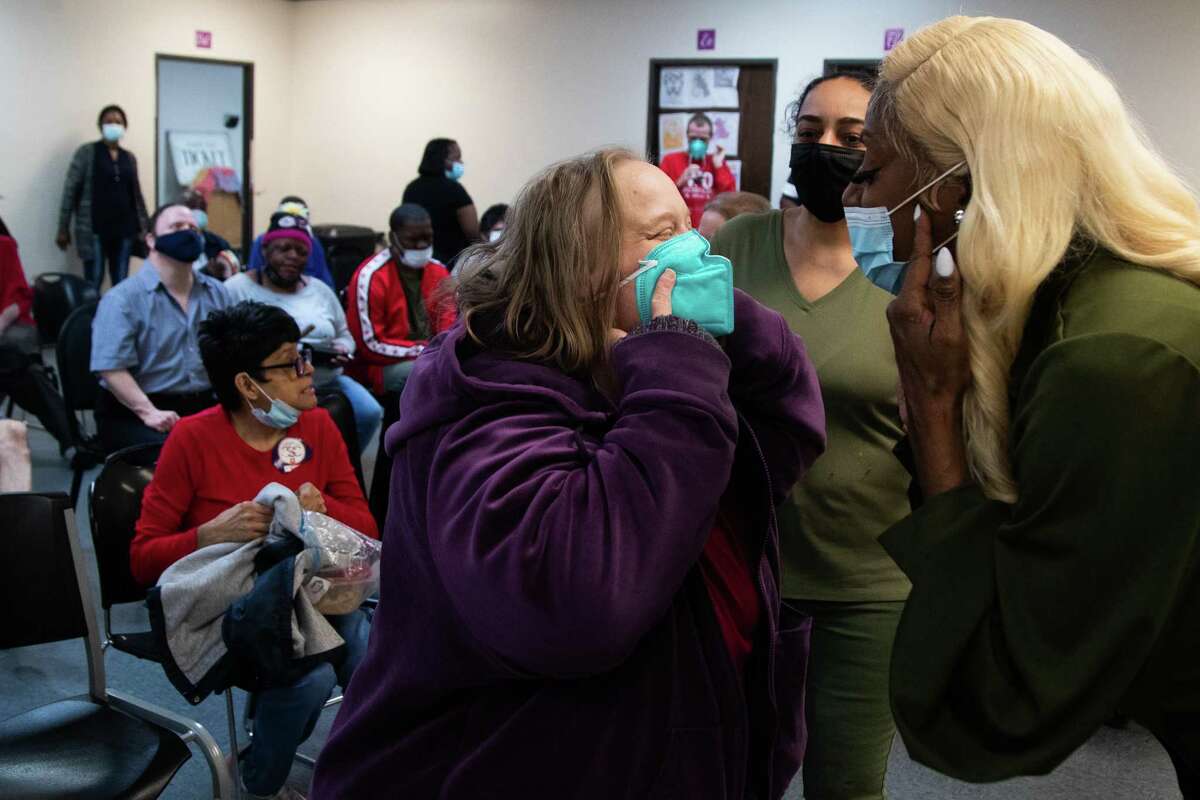 Naomi Perimeter, left, and Rosetta Douglas, director of Caregiver Inc. day hab, smile at each other during a worship service, Wednesday, March 16, 2022, in Sugar Land.  The helper is a place that provides long-term care to people with disabilities.