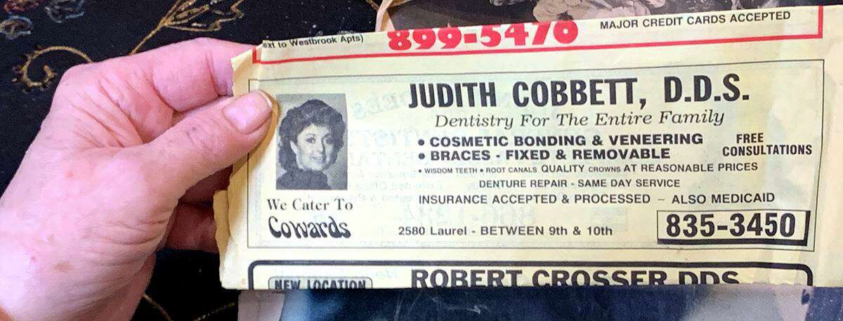A telephone book ad for Judith Cobbett's practice with the slogan, "We Cater to Cowards."