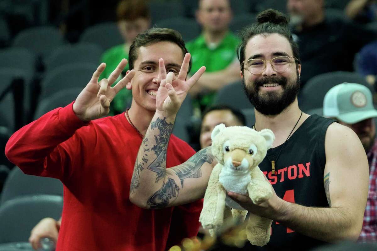 Cougars fans joke around with a stuffed cougar before an NCAA South Region men’s basketball final Saturday, March 26, 2022 in San Antonio.