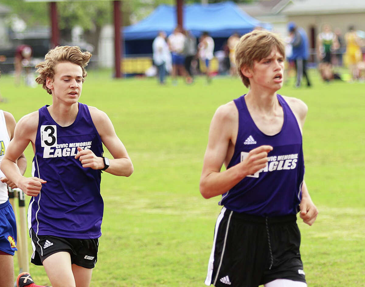 CM's Justice Eldridge (right) and Jackson Collman run in a race last season at the Madison County Meet in Wood River. Both Eagles runners won distance medals Saturday at the Illinois Top Times meet in Bloomington.